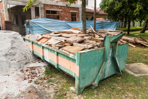 Cluttered garage being cleared by professionals in Dulwich